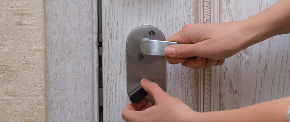 A homeowner using a deadbolt lock in Brooklyn.