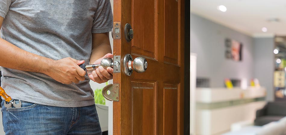 Locksmith unlocking a door in Queens, NY.